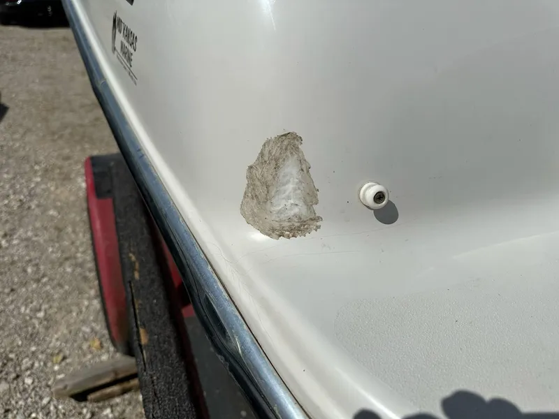 Slide: The Image of 1998 Four Winns 190 Horizon boat with hull damage, close-up view. - 21