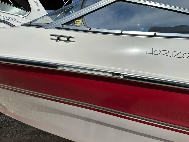 Slide: The Image of 1998 Four Winns 190 Horizon boat with red and white exterior detailing. - 25