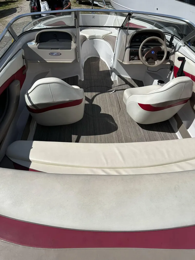 Slide: The Image of 1998 Four Winns 190 Horizon boat interior with white and red seating, steering wheel, and dashboard. - 3