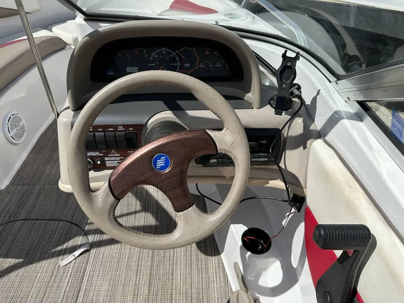 Slide: The Image of 1998 Four Winns 190 Horizon boat dashboard with steering wheel and controls. - 35