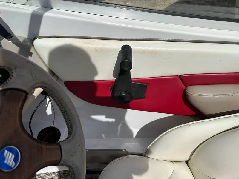 Slide: The Image of Interior of a 1998 Four Winns 190 Horizon boat, featuring steering wheel and door handle. - 36