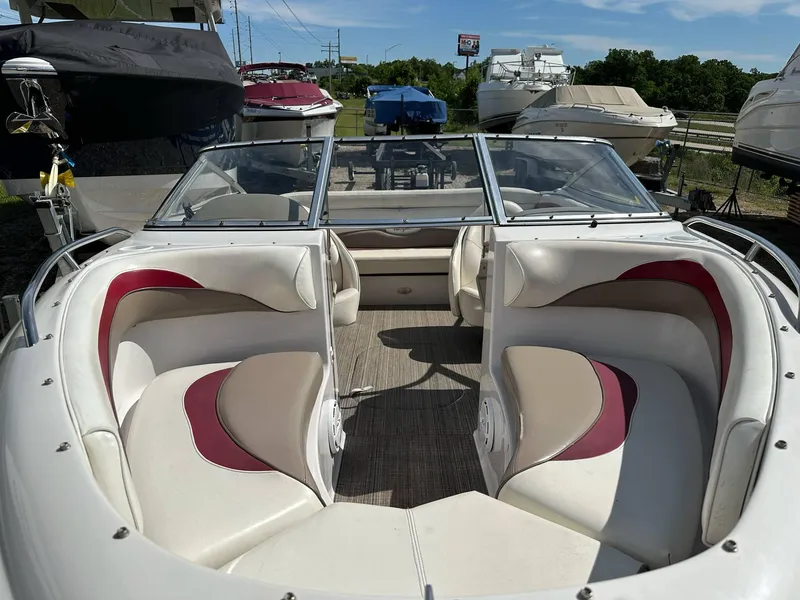 Slide: The Image of 1998 Four Winns 190 Horizon boat interior with red and beige seating, docked outdoors. - 41