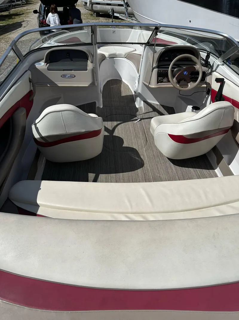 Slide: The Image of 1998 Four Winns 190 Horizon boat interior with white and red seating, steering wheel, and dashboard. - 5