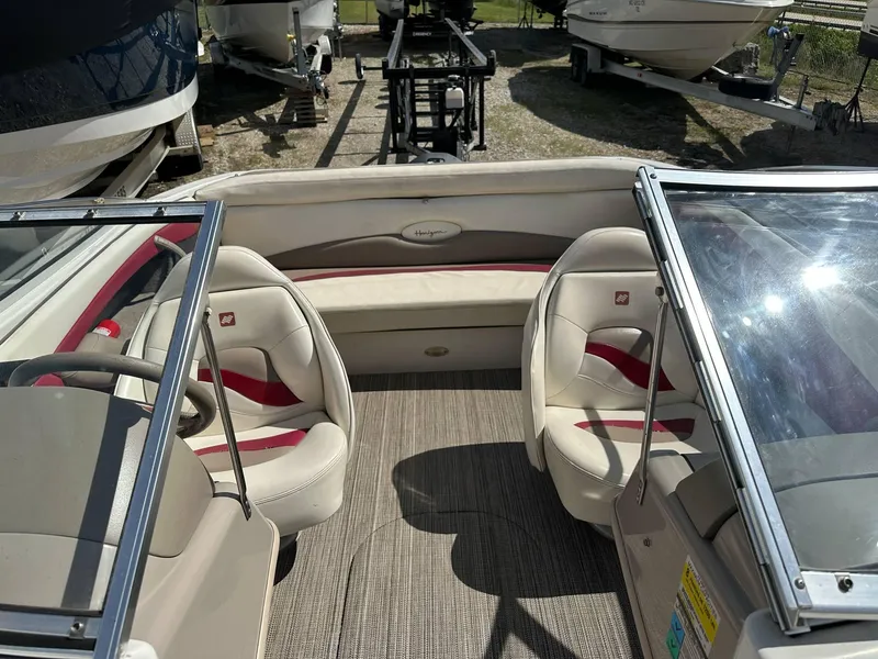 Slide: The Image of 1998 Four Winns 190 Horizon boat interior with beige and red seating. - 8