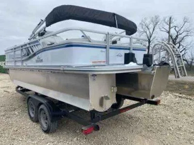 Slide: The Image of 2025 SunCatcher Select 322SS pontoon boat on trailer, featuring sleek design and sturdy construction. - 2