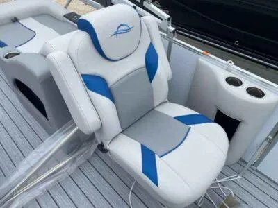 Slide: The Image of 2025 SunCatcher Select 322SS boat seat with blue and gray accents, cup holders visible. - 5