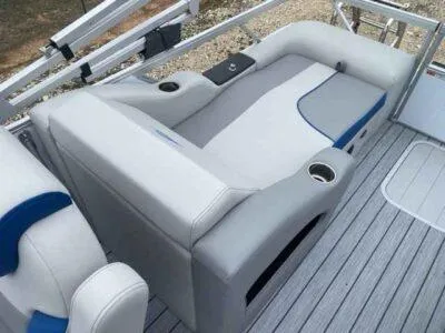 Slide: The Image of 2025 SunCatcher Select 322SS boat interior with gray seating and cup holders. - 7