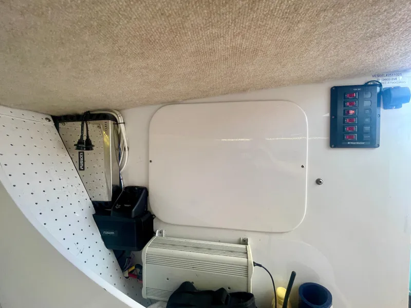 Slide: The Image of Interior view of a 1966 Bertram 25 Moppie boat, featuring electrical panel and equipment. - 14