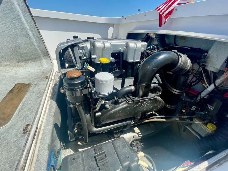 Slide: The Image of Engine compartment of a 1966 Bertram 25 Moppie boat, showcasing mechanical components. - 17