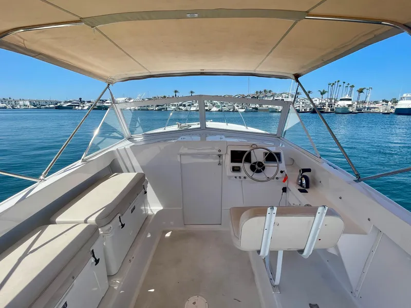 Slide: The Image of 1966 Bertram 25 Moppie boat interior with helm, seating, and ocean view. - 8