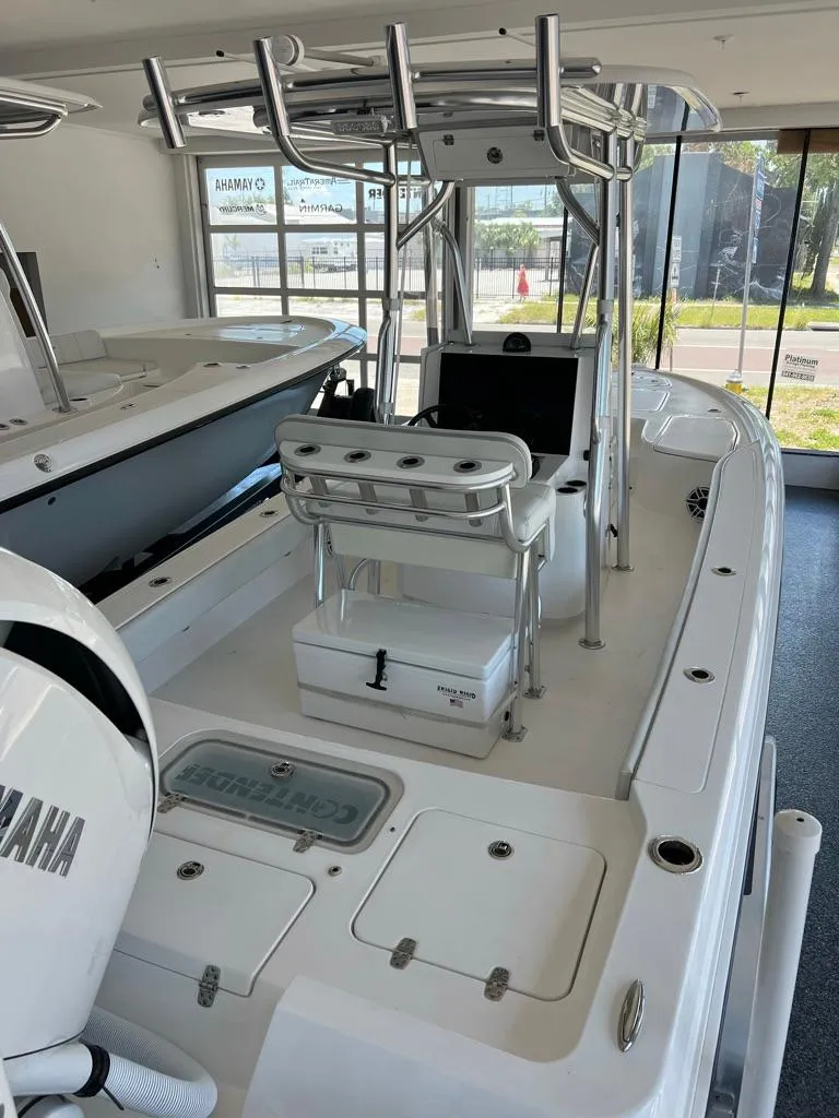 Slide: The Image of 2025 Contender 23 Bay boat with Yamaha engine in showroom. - 10