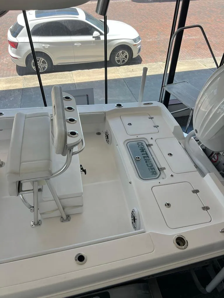 Slide: The Image of 2025 Contender 23 Bay boat interior with seating and storage compartments. - 12