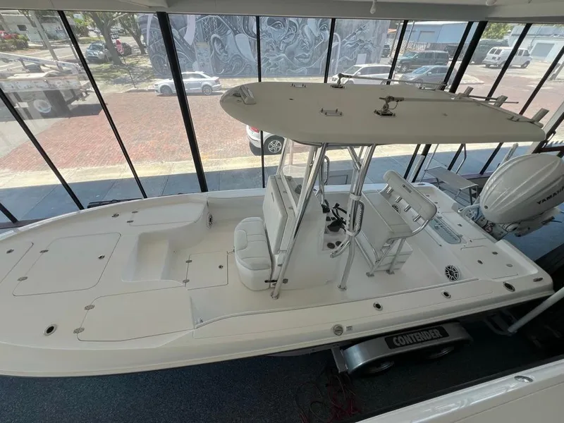 Slide: The Image of 2025 Contender 23 Bay boat displayed indoors, featuring sleek design and modern equipment. - 3