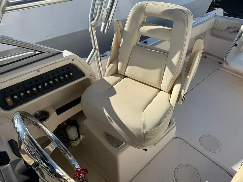 Slide: The Image of 2007 Grady-White Journey 258 boat cockpit with steering wheel and captain's chair. - 10