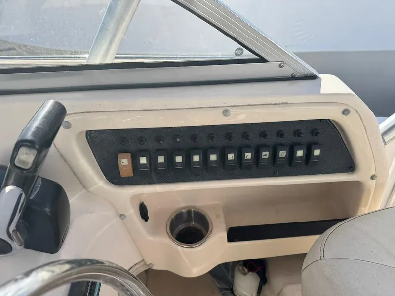 Slide: The Image of 2007 Grady-White Journey 258 boat dashboard with control panel and steering wheel. - 11