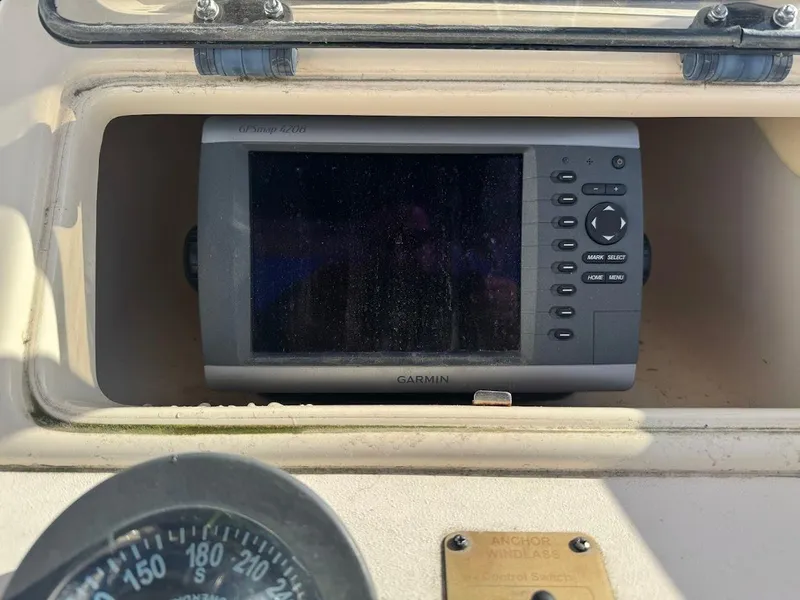 Slide: The Image of 2007 Grady-White Journey 258 boat dashboard with Garmin GPS device and compass. - 12