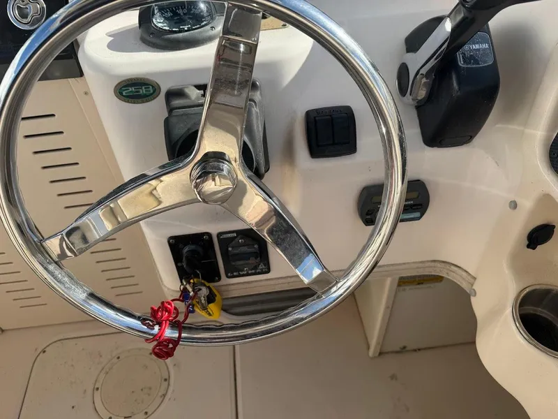 Slide: The Image of Steering wheel of a 2007 Grady-White Journey 258 boat cockpit. - 13