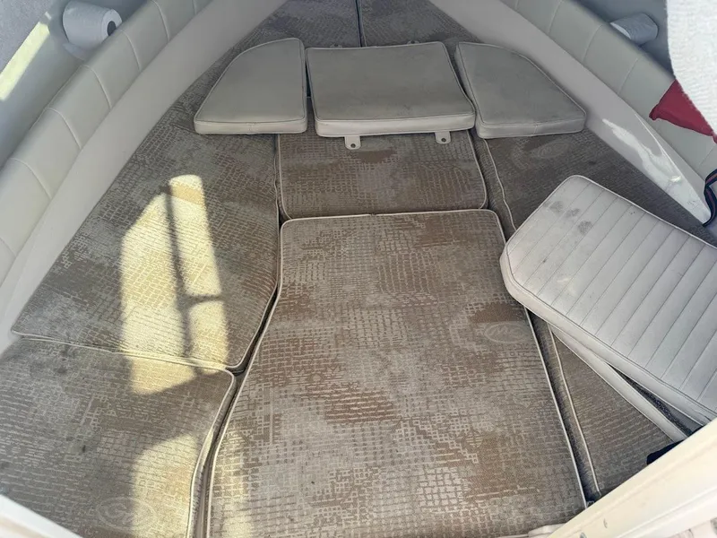 Slide: The Image of 2007 Grady-White Journey 258 cabin interior with cushioned seating and carpeted flooring. - 14