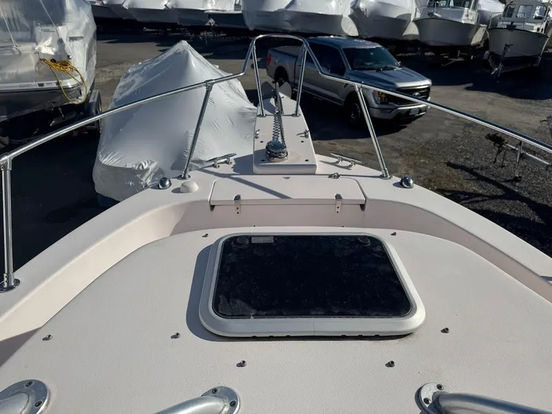 Slide: The Image of 2007 Grady-White Journey 258 boat deck with hatch, parked near covered boats. - 15