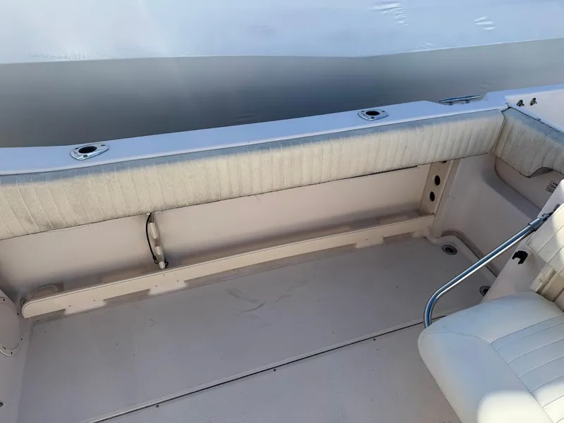 Slide: The Image of 2007 Grady-White Journey 258 boat interior with cushioned seating and rod holders. - 16