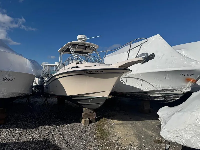 Slide: The Image of 2007 Grady-White Journey 258 boat stored outdoors, surrounded by covered boats. - 2