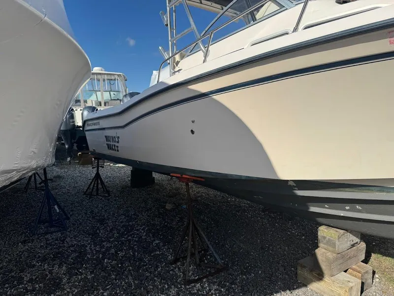 Slide: The Image of 2007 Grady-White Journey 258 boat on stands, side view, outdoors. - 3