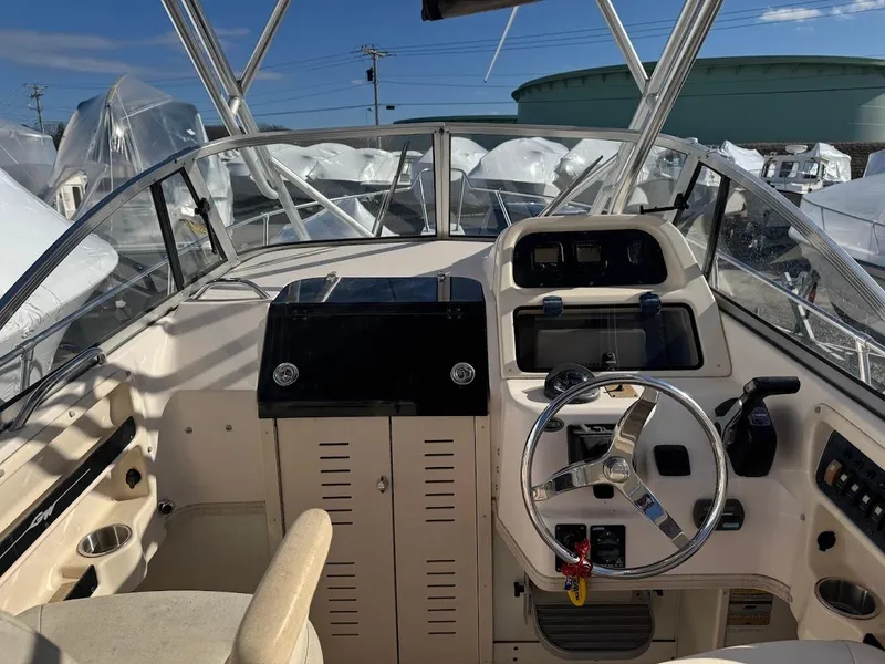 Slide: The Image of 2007 Grady-White Journey 258 boat cockpit with steering wheel and control panel. - 9