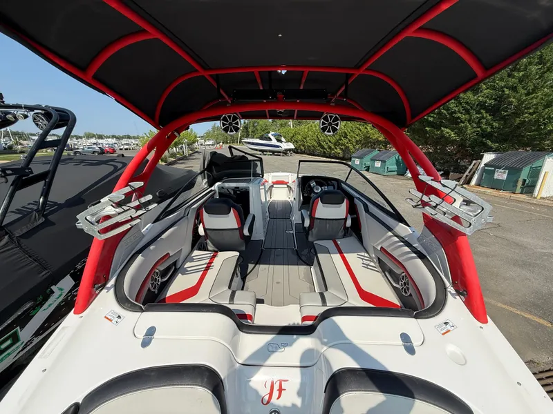 Slide: The Image of 2019 Yamaha Boats 242X E-Series interior with red accents and spacious seating. - 11