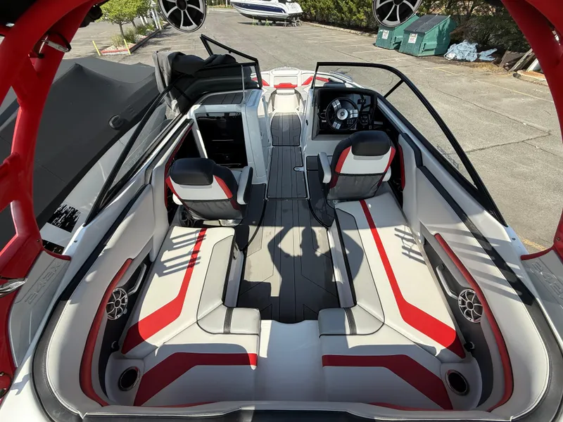 Slide: The Image of 2019 Yamaha Boats 242X E-Series interior with red and white seating, steering wheel, and speakers. - 12