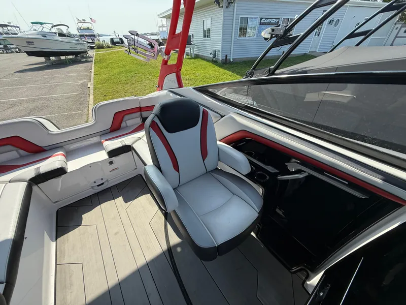 Slide: The Image of 2019 Yamaha Boats 242X E-Series interior with captain's chair and sleek design. - 15