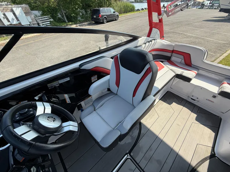 Slide: The Image of 2019 Yamaha Boats 242X E-Series interior with sleek seating and modern steering wheel. - 16