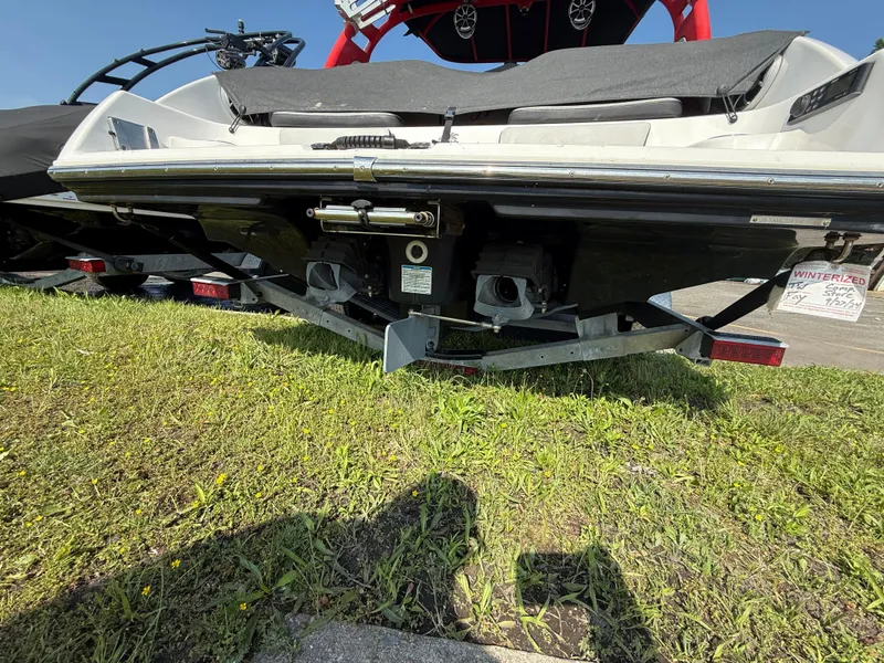 Slide: The Image of 2019 Yamaha Boats 242X E-Series on trailer, rear view, parked on grass. - 6