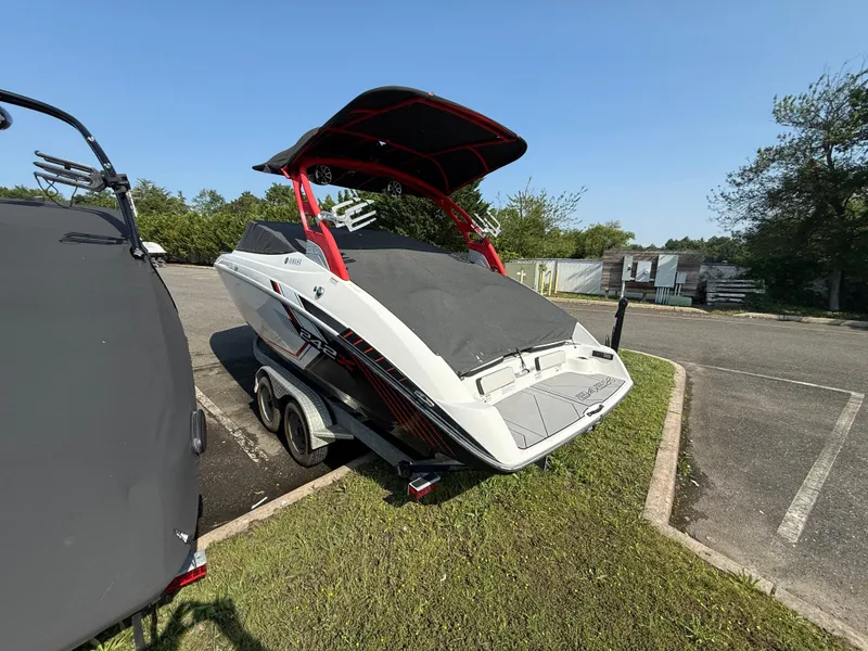 Slide: The Image of 2019 Yamaha Boats 242X E-Series on trailer in parking lot, covered and ready for transport. - 8