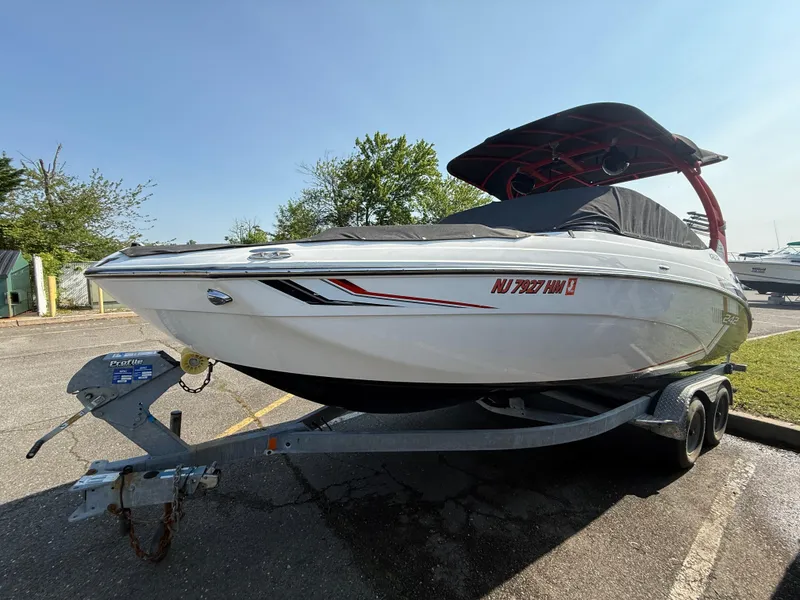 Slide: The Image of 2019 Yamaha Boats 242X E-Series on trailer, parked outdoors, with cover and canopy. - 9