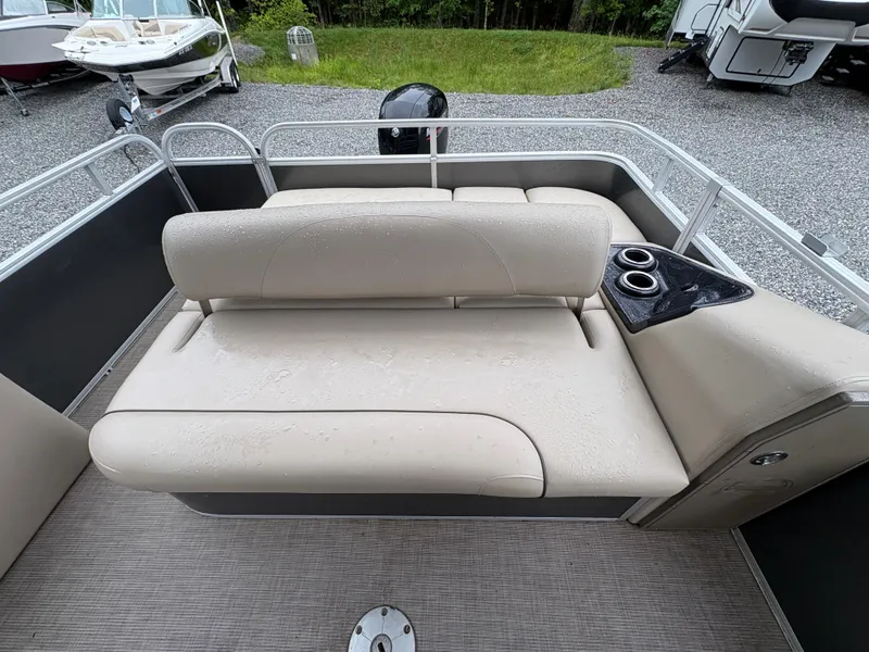 Slide: The Image of 2022 Sun Tracker PARTY BARGE interior with beige seating and cup holders. - 11