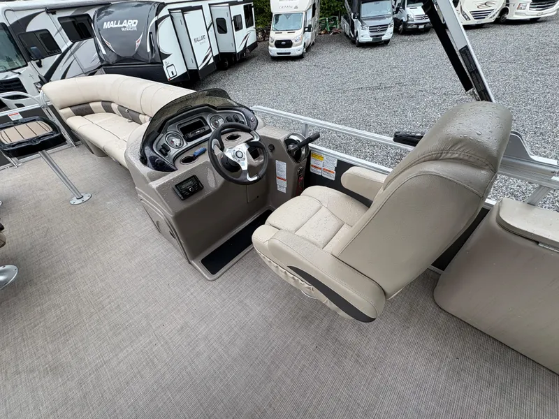 Slide: The Image of 2022 Sun Tracker PARTY BARGE interior with beige seating and modern dashboard. - 16