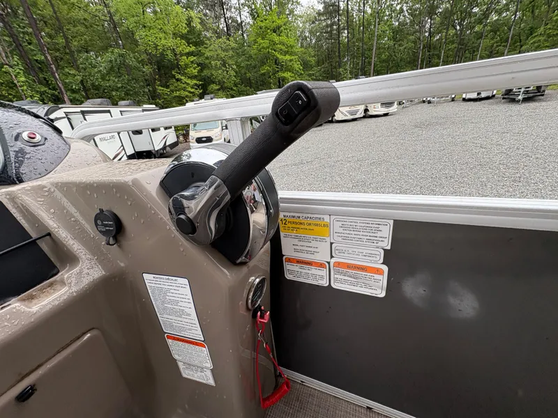 Slide: The Image of 2022 Sun Tracker PARTY BARGE control panel with throttle lever and safety instructions. - 19