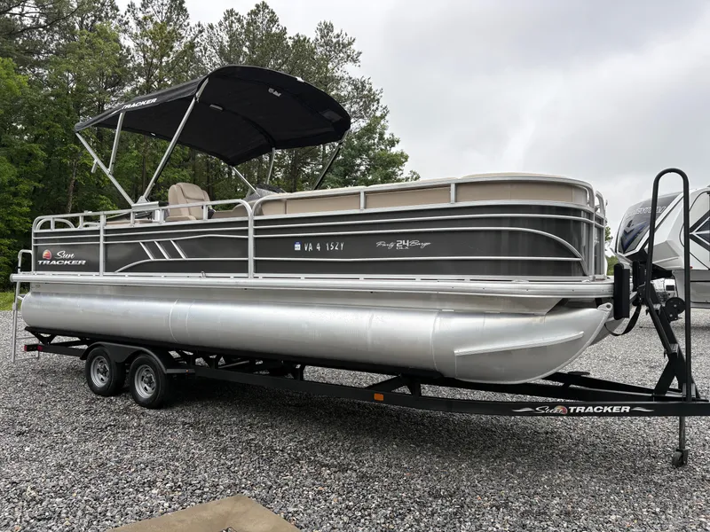 Slide: The Image of 2022 Sun Tracker PARTY BARGE pontoon boat on trailer, parked on gravel. - 5