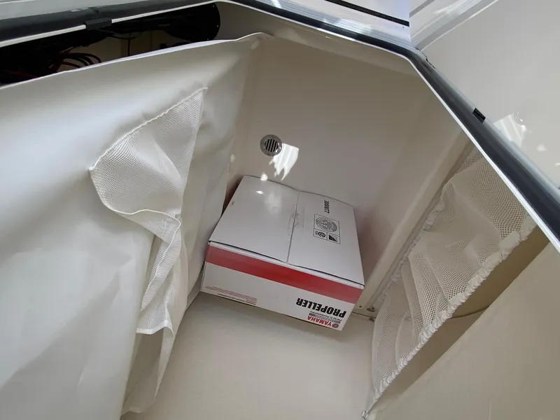 Slide: The Image of Storage compartment of 2025 Pioneer 202 Islander boat with a box inside. - 12