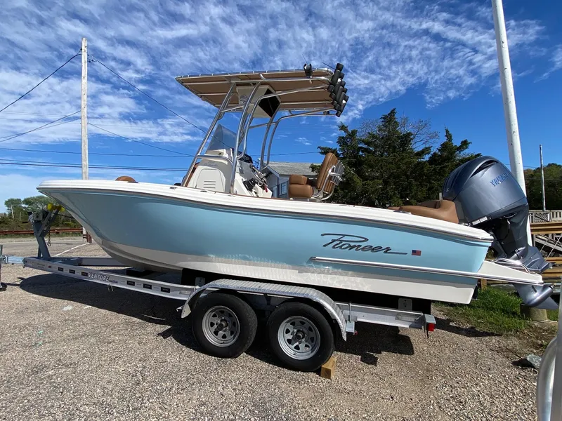Slide: The Image of 2025 Pioneer 202 Islander boat on trailer under clear blue sky. - 2