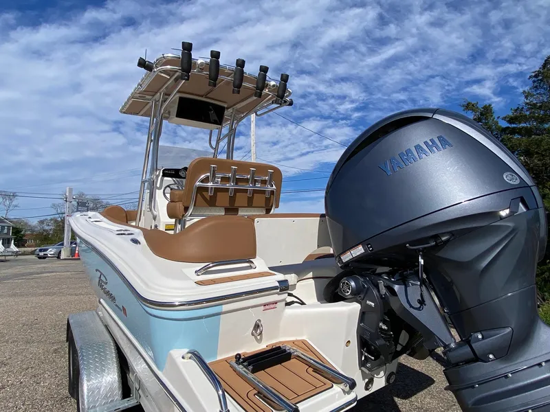 Slide: The Image of 2025 Pioneer 202 Islander boat with Yamaha engine, parked on a trailer under a blue sky. - 4