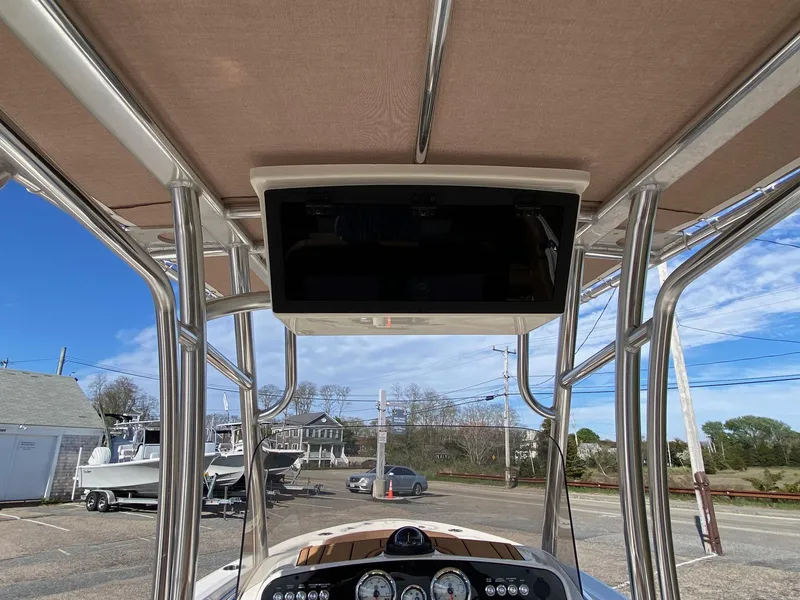 Slide: The Image of 2025 Pioneer 202 Islander boat console with canopy and clear sky background. - 7