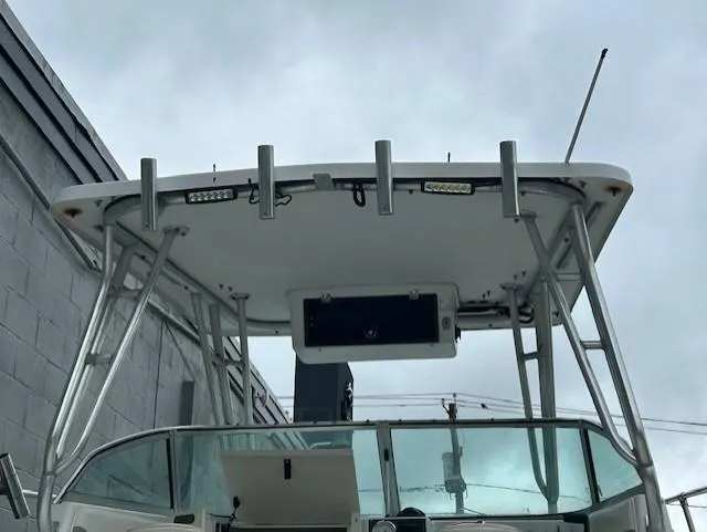 Slide: The Image of 2000 Seaswirl Striper 2600 Walkaround O/B boat with T-top and rod holders. - 4