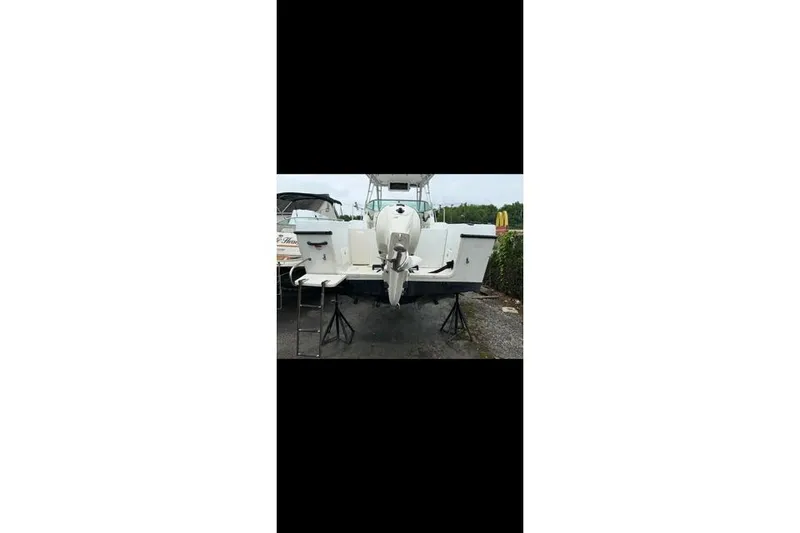 Slide: The Image of 2000 Seaswirl Striper 2600 Walkaround O/B boat on stands, rear view. - 5