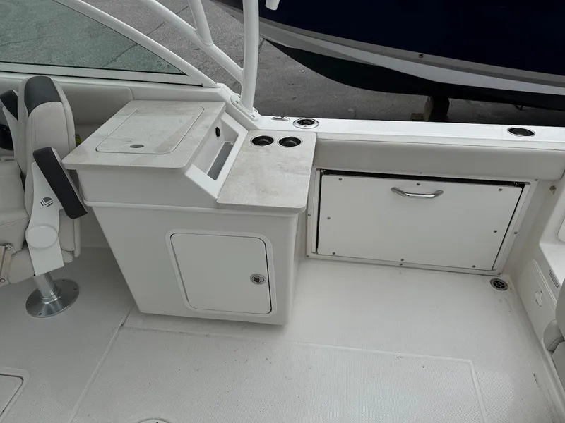 Slide: The Image of 2023 Sailfish 245 DC boat interior with storage compartments and seating. - 5