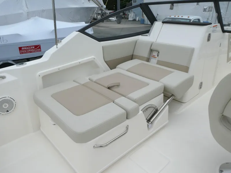 Slide: The Image of 2025 Boston Whaler 210 Vantage boat interior with beige seating and modern design. - 10