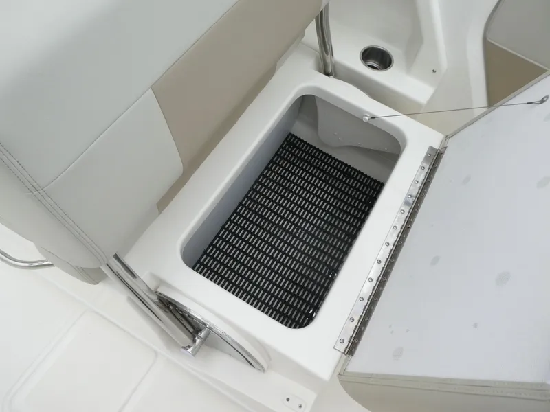Slide: The Image of Open storage compartment on a 2025 Boston Whaler 210 Vantage boat. - 11