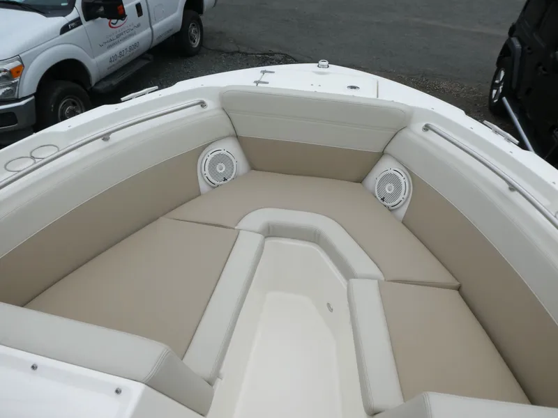 Slide: The Image of 2025 Boston Whaler 210 Vantage boat interior with beige seating and speakers. - 14