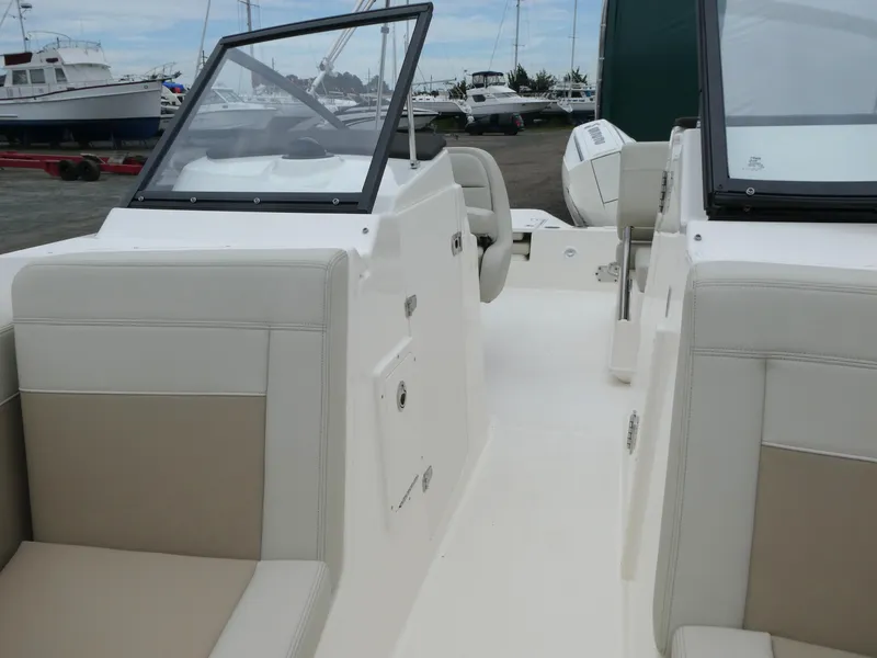 Slide: The Image of 2025 Boston Whaler 210 Vantage boat interior with beige seating and windshield. - 15