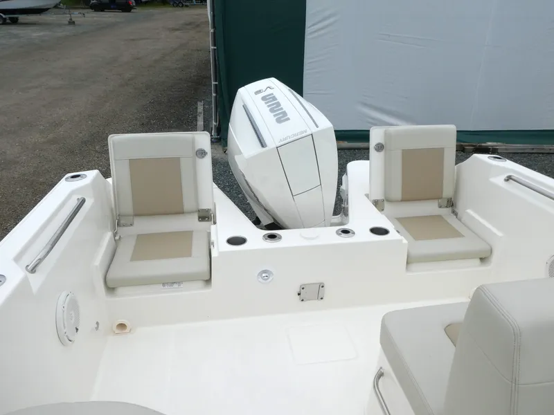 Slide: The Image of 2025 Boston Whaler 210 Vantage boat interior with seating and outboard motor. - 5